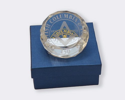 a photo of the 150 year commemorative grand lodge of british columbia and yukon chrystal paper weight.